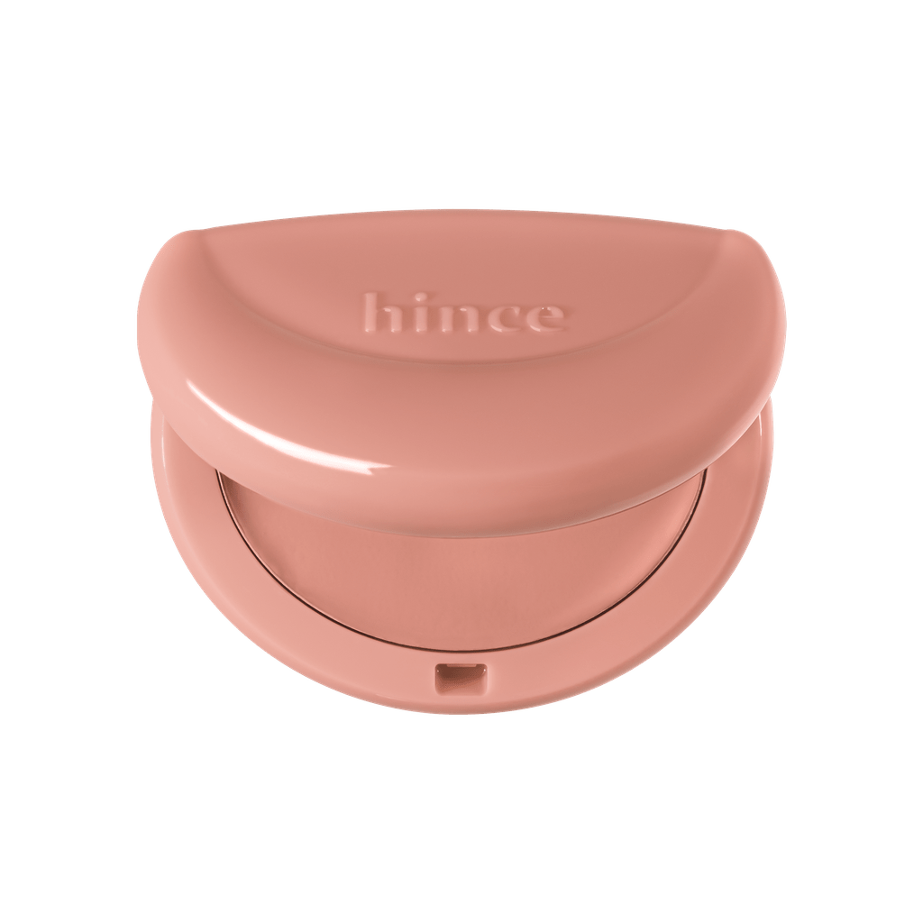 Hince Half-Moon Cheek Cream to Powder Blush in a compact, with a half-moon shape and soft pink color on a clean background.