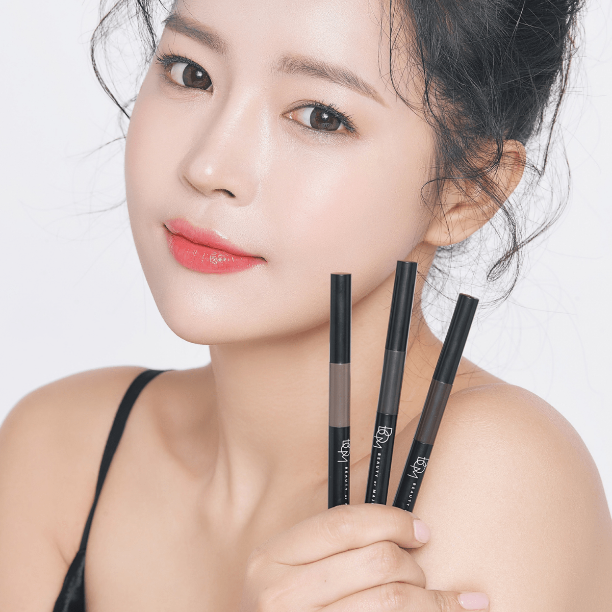 B.O.M 3-in-1 Triple Edge Eyebrow tool with multiple shaping edges for precise eyebrow grooming and styling.