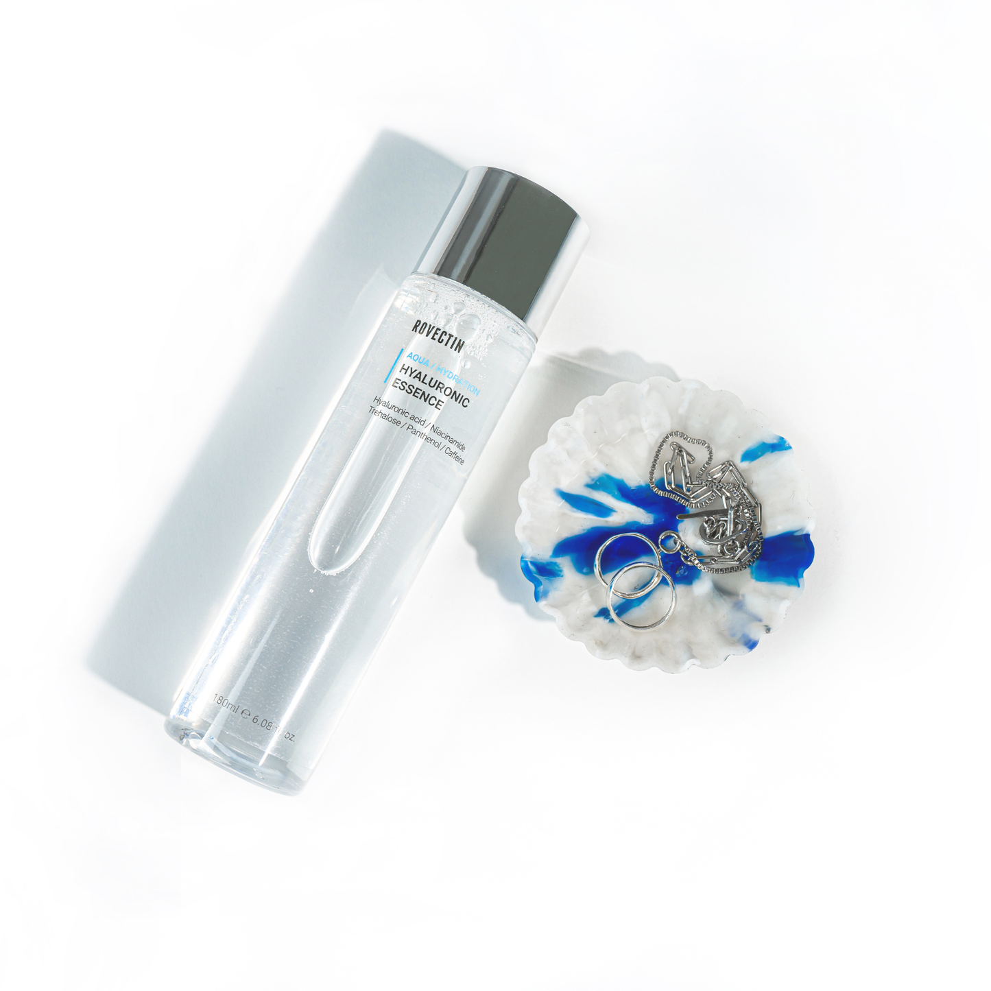 Rovectin Hyaluronic Essence bottle with clear liquid inside, 180ml, skincare product for hydration and moisturizing.