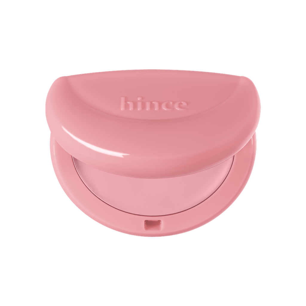 Hince Half-Moon Cheek Cream to Powder Blush in a compact with a half-moon shape and soft pink color on a white background.