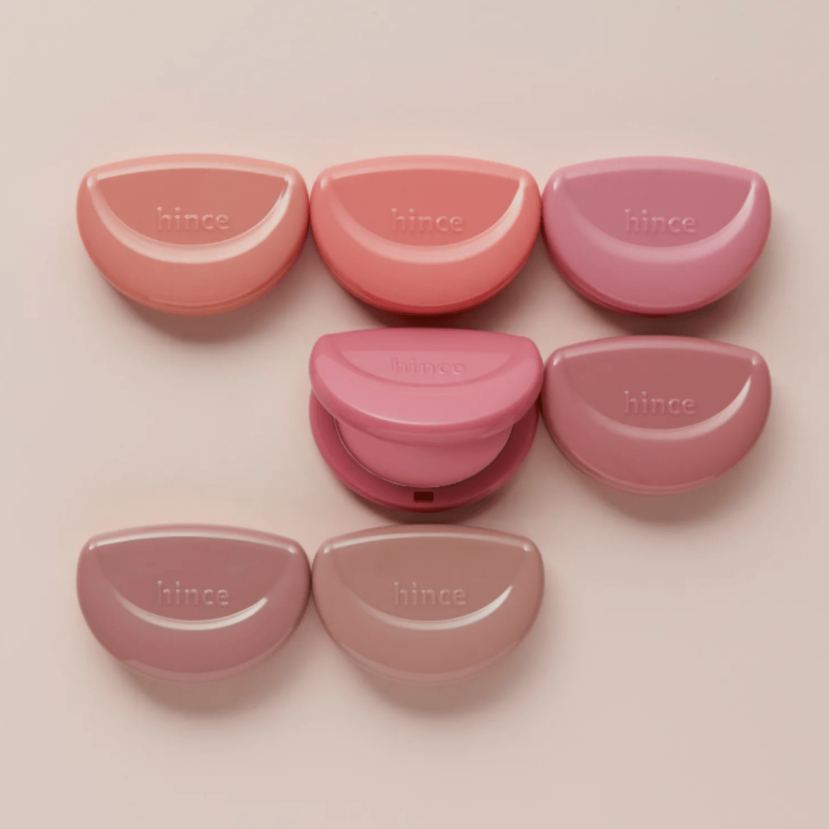 Hince Half-Moon Cheek Cream to Powder Blush in a compact with a half-moon shape, featuring soft pink and peach tones.