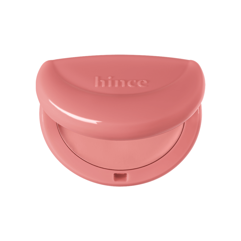 Hince Half-Moon Cheek Cream to Powder Blush in a compact with a half-moon shape, showcasing its smooth creamy texture and natural pink shade.