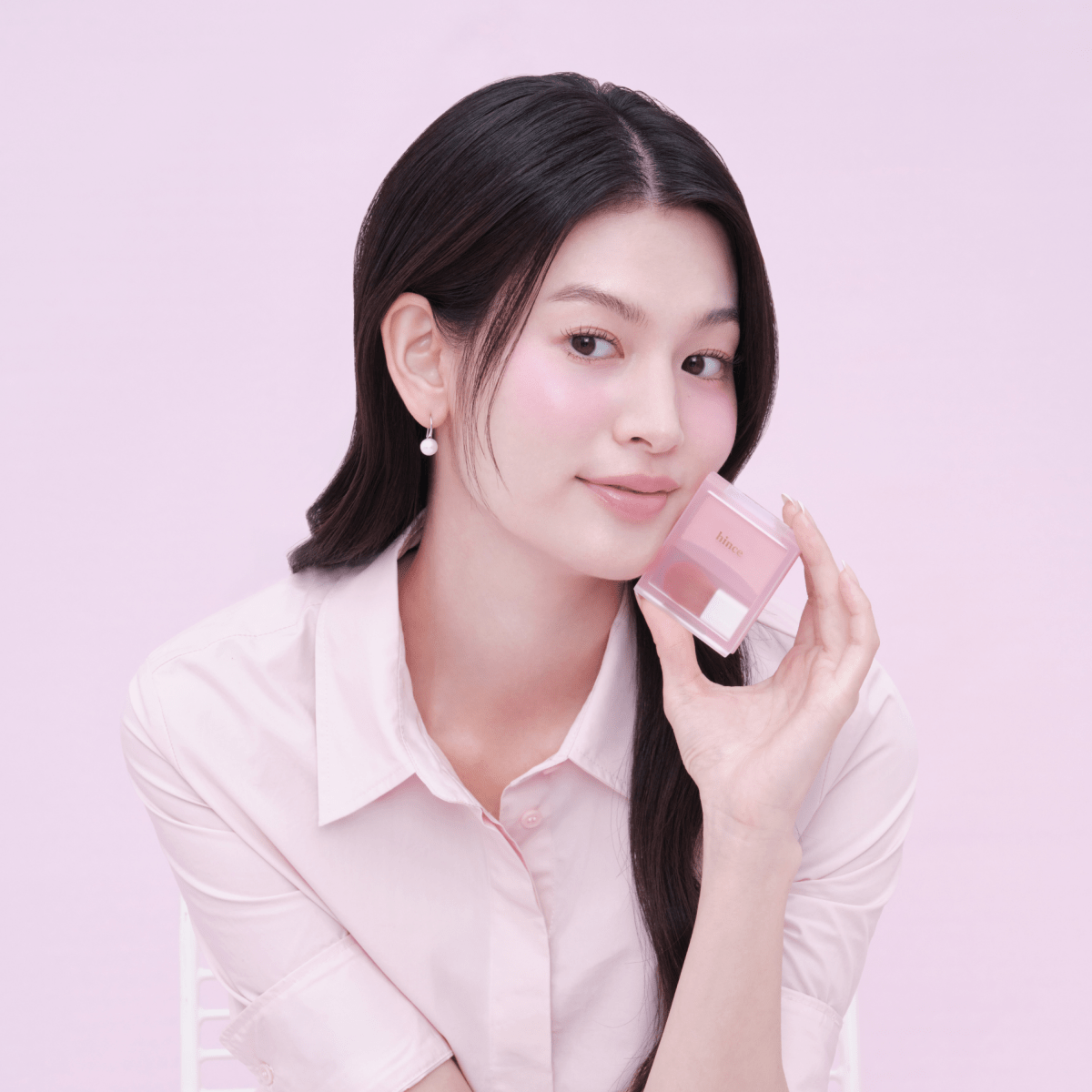 Hince Hug Layer Cheek Blush in a compact with soft pink and coral shades, showcasing its smooth, blendable texture on a neutral background.