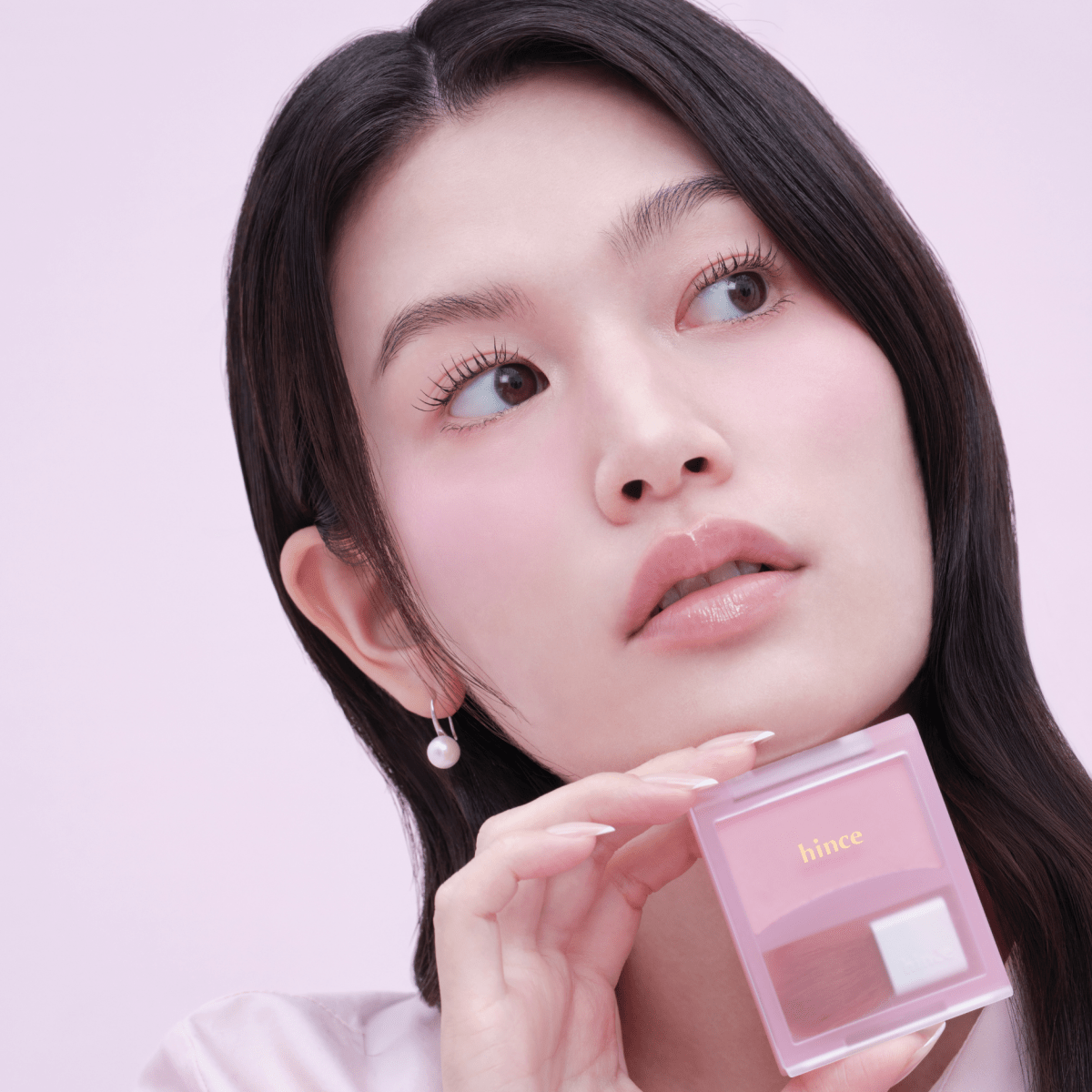 Hince Hug Layer Cheek Blush in soft pink shade, showcasing the blush compact with a smooth, blended application on the cheek.