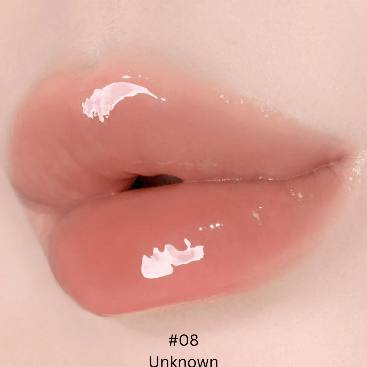 Hince Mirror Dew Gloss lip gloss with shiny, reflective finish, featuring a sleek tube and applicator brush.