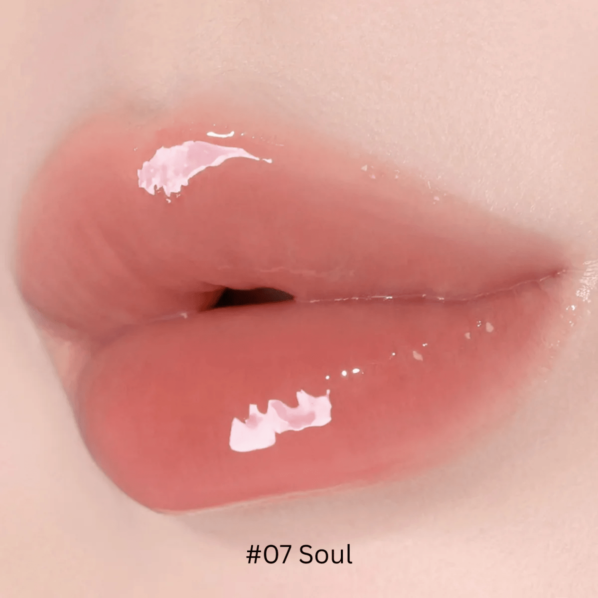 Hince Mirror Dew Gloss lip gloss in a clear tube with shiny, reflective finish, showcasing its glossy, moisturizing formula.