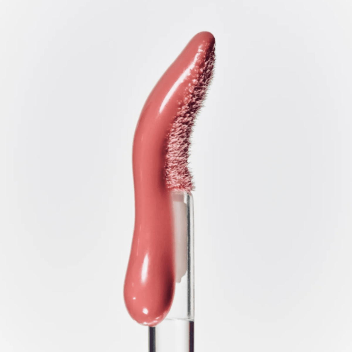 Hince Mirror Dew Gloss lip gloss in a sleek tube, featuring shiny, moisturizing formula for a glossy lip look