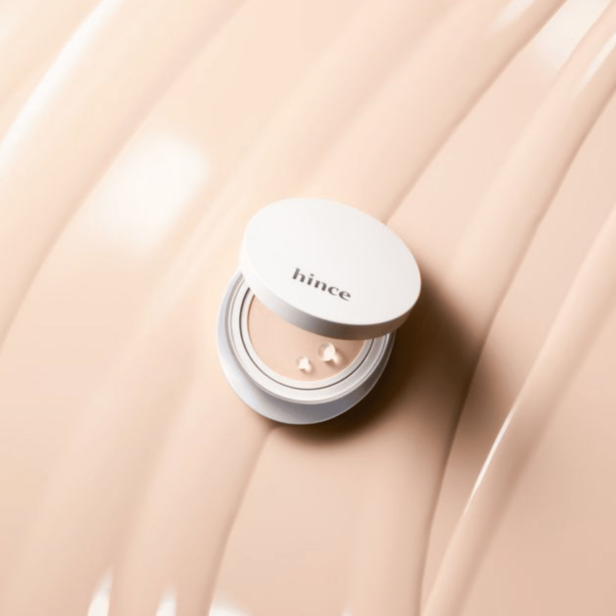 Hince Nu Glow White Cushion foundation in a compact with a mirror, showcasing its sleek packaging and smooth surface.