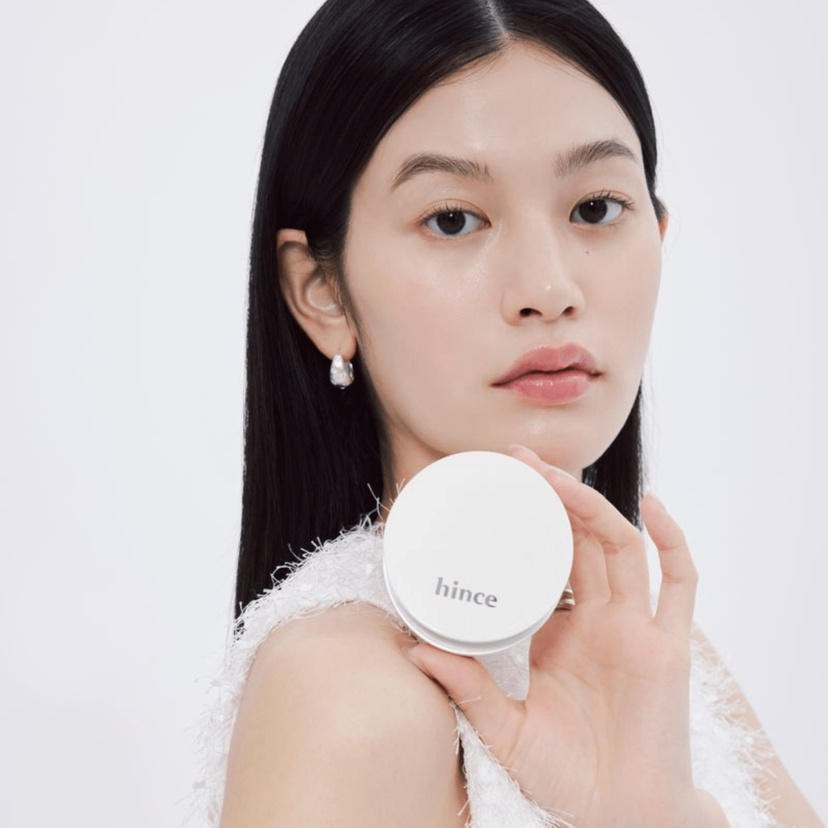 Hince Nu Glow White Cushion, a foundation cushion with a compact case, showcasing flawless, radiant skin coverage.