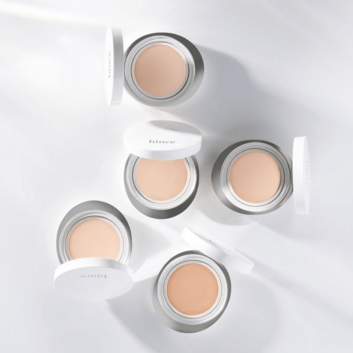 Hince Nu Glow White Cushion foundation compact with a sleek white case, lightweight makeup for a natural glow.