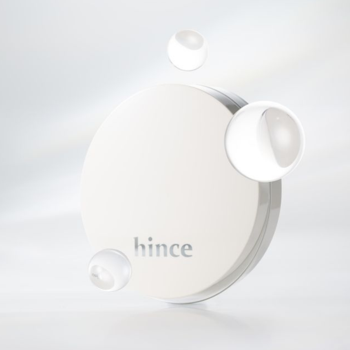 Hince Nu Glow White Cushion foundation in a compact with a white and silver design, showcasing its lightweight, glowing finish.