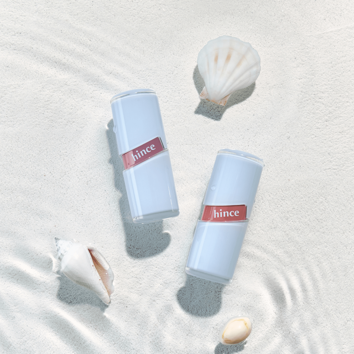 Hince Raw Glow Gel Tint Chill Voyage Edition lip tint in a clear tube with a doe-foot applicator, showcasing its vibrant color.